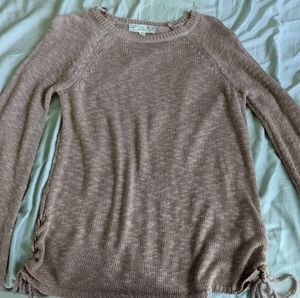 Pink sweater with braids at the end